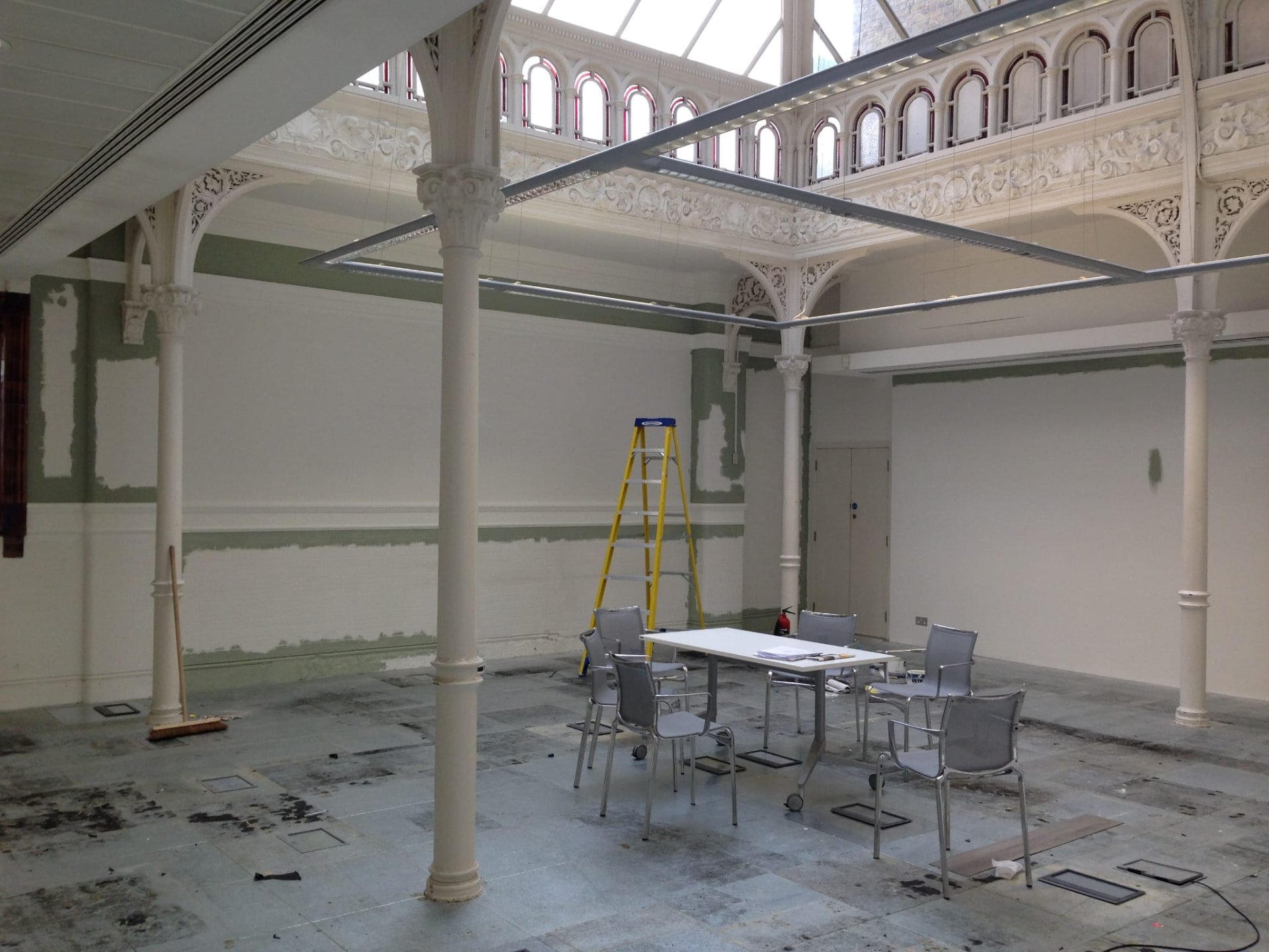 Heritage atrium mid-refurbishment with cast iron columns, glazed roof and new ceiling framework