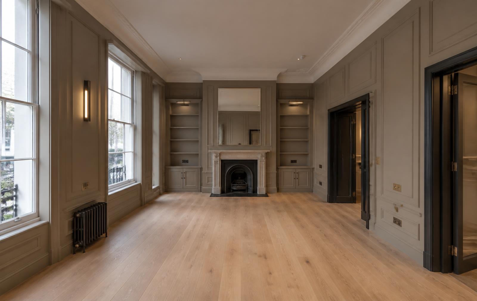 High-spec refurbished London reception room with panelled walls and oak flooring